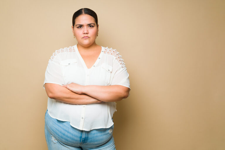Upset fat woman looking annoyed and looking at the camera